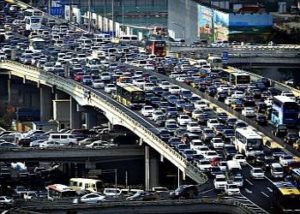 Lines of cars are pictured during a rush hour traffic jam on Guomao Bridge in Beijing...Lines of cars are pictured during a rush hour traffic jam on Guomao Bridge in Beijing July 11, 2013. Eight more cities in China, the world's biggest auto market, are likely to announce policies restricting new vehicle purchases, an official at the automakers association said, as Beijing tries to control air pollution. REUTERS/Jason Lee (CHINA - Tags: TRANSPORT ENVIRONMENT BUSINESS TPX IMAGES OF THE DAY)